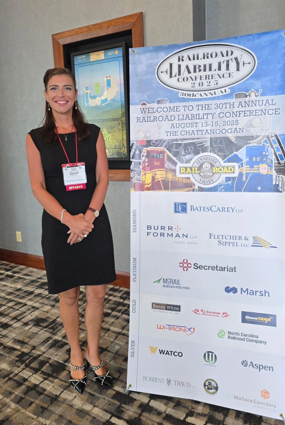 Sarah N. Dimmich beside the banner for the 30th Annual Railroad Liability Conference, Chattanooga, August 2025