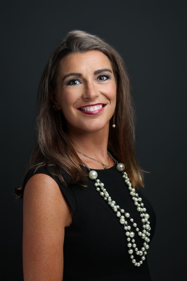 Sarah N. Dimmich in a black dress and pearls